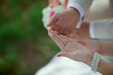 新娘和新郎的手握着一个红色的女虫命运的迹图片