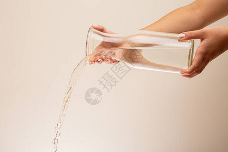 水倒入玻璃杯水倒在水面上在白色图片