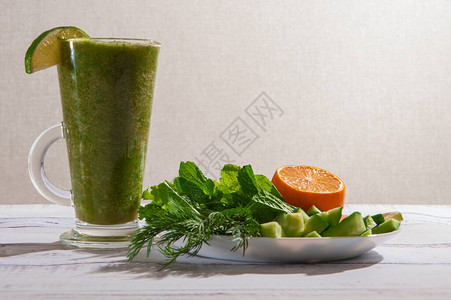 绿色沙拉大菜黄瓜鳄梨薄荷长清晰玻璃中的石灰以及绿粒和柠檬图片