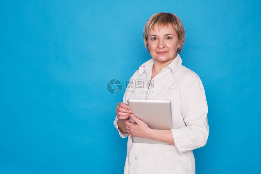 穿白色大衣和蓝色背景的平板医生女士图片
