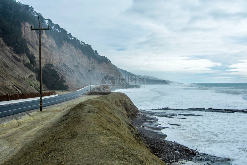 这条路沿着海洋延伸沿山的电力支柱水面上的雾美丽的水平景观质量图片
