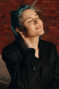 白人可爱的女人摸着她新的蓝色发型在日图片