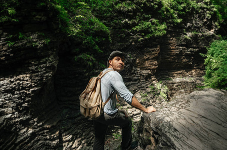 吸引人的徒步旅行者带着背包穿过树林图片