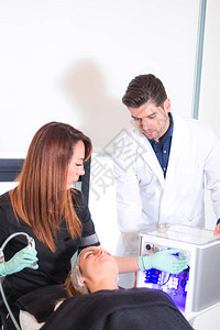 美学医医生监督美容师要应用到病人身上的面部治療过程图片