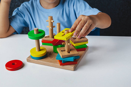 儿童木制玩具大脑半球间发育委员会孩子们的手特写儿童发育迟缓语言治疗师的木制迷宫蒙台背景图片