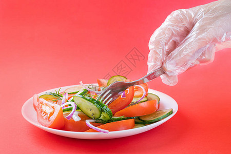 番茄黄瓜洋葱等蔬菜沙拉和白盘中亮红底的白色面粉图片