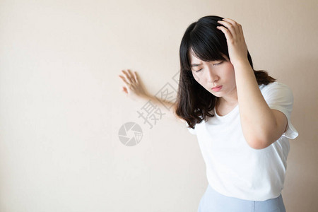 年轻的亚洲女在白色背景下患有头晕眩晕和头痛头晕的原因包括偏头痛压力中风美尼尔氏病或脑肿背景图片