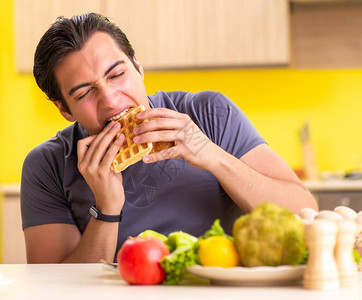 男人在健康饮食和不健康食物之间图片