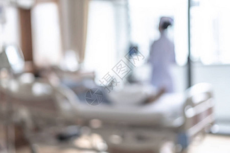 医院病床模糊背景的护士理病人带医院保健服务或保健康复治疗的医学模糊图片