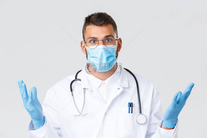 戴着眼镜医用口罩和手套的西班牙裔英俊医生的特写镜头图片