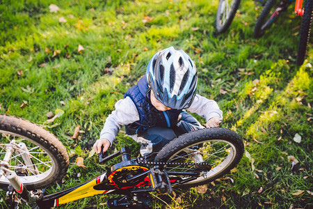 骑自行车的男孩自行车修理修理他的自行车的小男孩儿童机械师图片