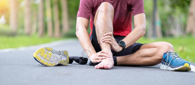 年轻的成年男在跑步时肌肉疼痛跑步者因脚踝扭伤或跟腱炎而腿痛运动损图片