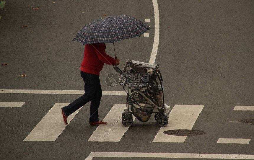 雨中撑伞行走图片