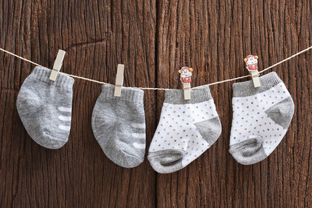 挂在木柴背景新生儿和婴儿概念上衣着线上图片