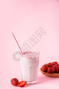 粉红色背景的鲜奶昔和草莓夏季脱毒饮图片