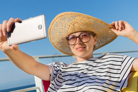 美丽浪漫的金发女郎在暑假乘船渡旅行时自拍画像图片