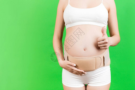 身穿怀孕紧身胸衣的孕妇贴身内衣背痛图片
