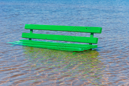 在被水淹没的沙滩上的木凳海上涨潮或涨水图片
