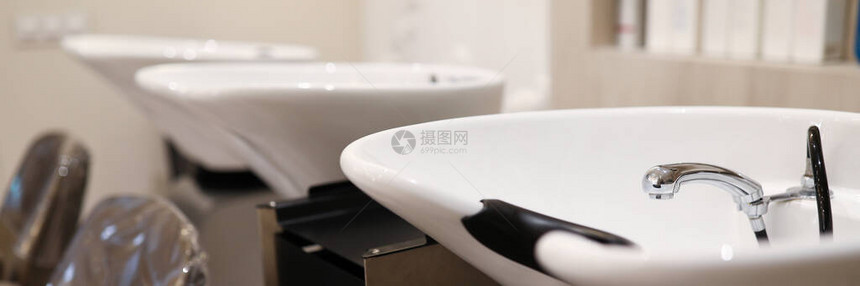 椅子的特写镜头靠近用于洗头发的白色水槽美发师造型师的洗衣机设备理发店的手续护发和现图片