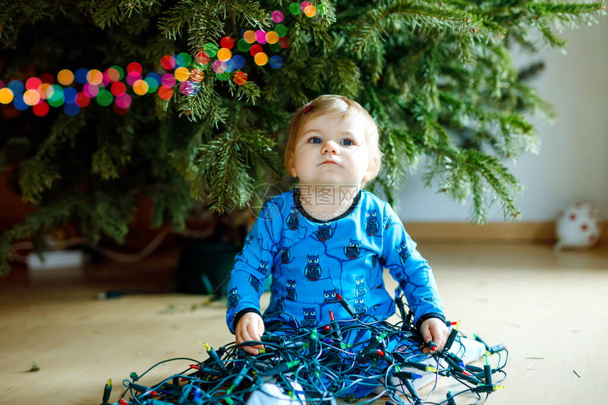 可爱的女婴从圣诞树上摘下节日装饰品儿童拿着轻园庆祝之后的家庭除图片