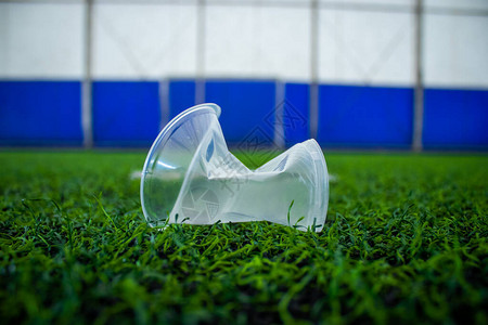 足球场草地上皱巴的塑料杯图片