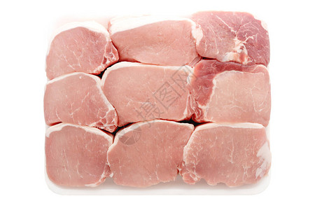 白色塑料容器中的无骨原生猪肉排图片