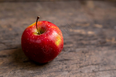 一个苹果把水滴放在木板图片