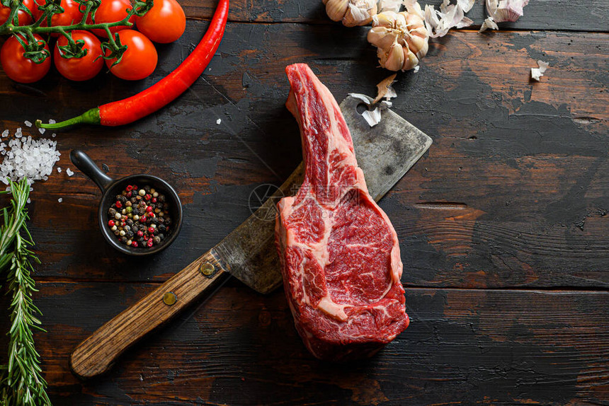在切肉刀上的牛排中的生骨有机农场大理石优质黑安格斯牛肉深色木质背景顶视图用调味料图片