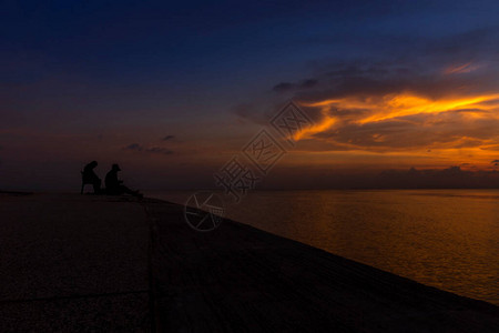 黄昏的天空湖边渔民的剪影图片