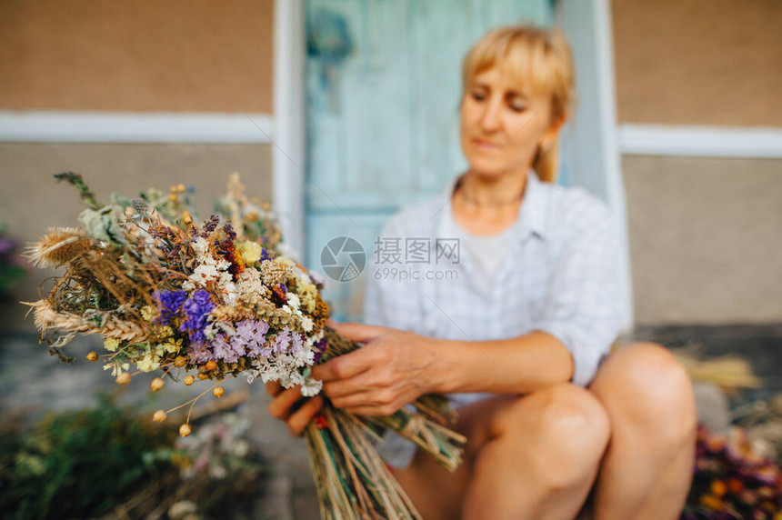 成年女手中的一束干花创造了一种构图花店制作了在该国花园中种植的图片