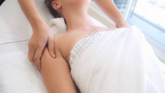 业余按摩师在豪华温泉疗养所为放松的女提供肩膀按摩健康复图片