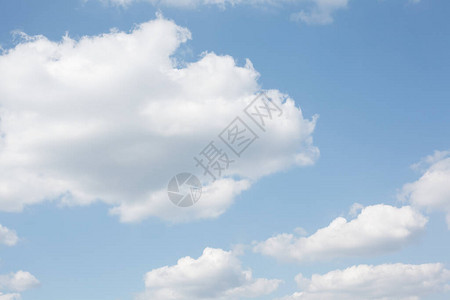 淡蓝色的天空上柔和的白色蓬松云彩图片