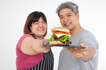 亚洲胖情侣笑快乐一起吃汉堡包吃健康图片