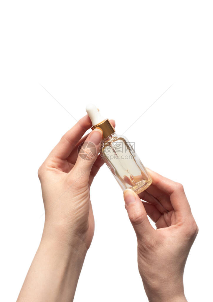 白种背景孤立的持有维生素油血清奶油瓶的妇女图片