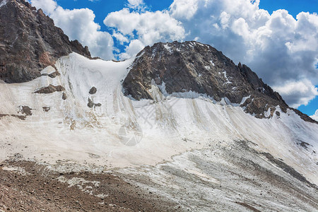 吉尔斯坦的山地景观山谷景观中的岩石雪和石头山全景吉尔斯坦阿拉图山脉图片