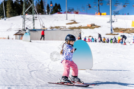 年轻的滑雪者在滑雪坡上玩得开心图片