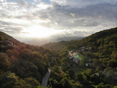 在圣吉尔哥伦比亚日落的绿色山环绕着绿山周围的建筑SanGilCo图片