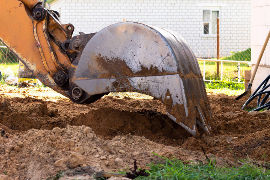 挖土机金属桶在建筑工地挖沙或图片
