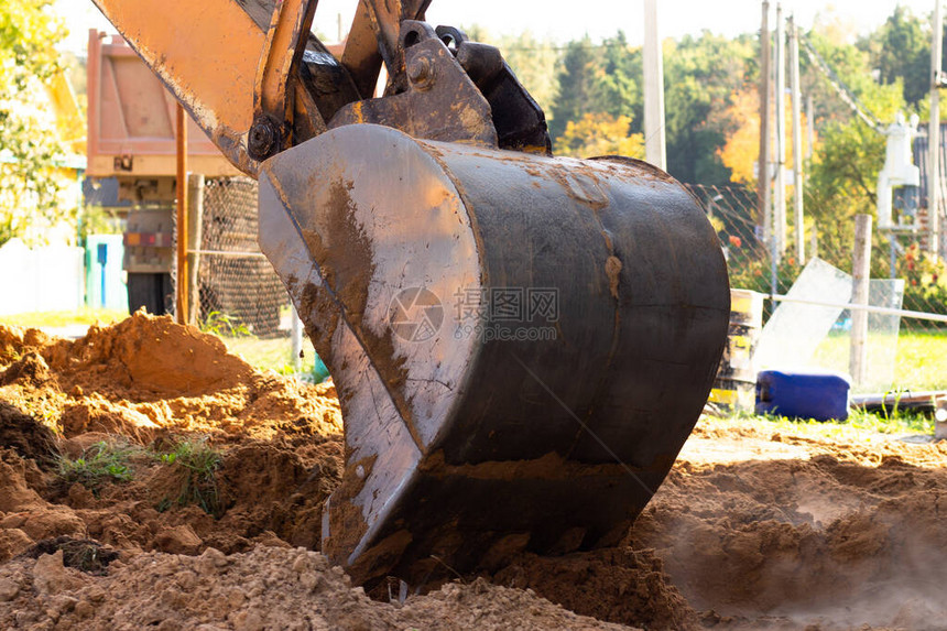 挖土机金属桶在建筑工地挖沙或图片
