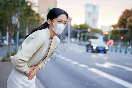 秋冬户外肚子疼痛的青年女性背景图片