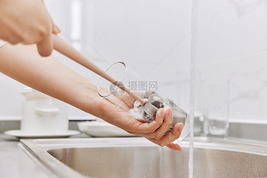 女性清洗玻璃杯特写图片