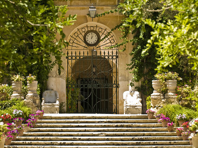 一座中世纪大门上的时钟通往美丽花园图片