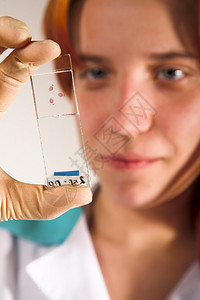 持有实验室测试样本的年轻妇女接受化验检图片