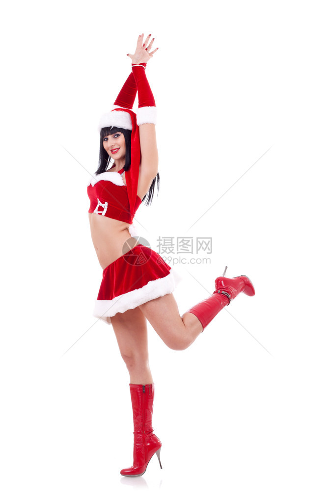 打扮成圣诞老人的女孩在白色背景上跳舞图片
