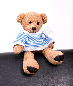 可爱的泰迪熊坐在家具上摄影背景图片