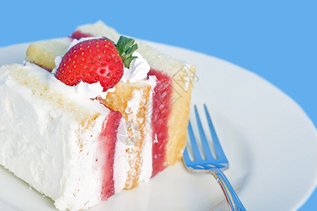带纹理的蓝色背景和小阴影的草莓奶油蛋糕背景图片