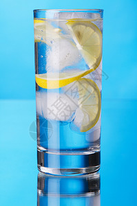 蓝色背景的柠檬冰水杯子图片