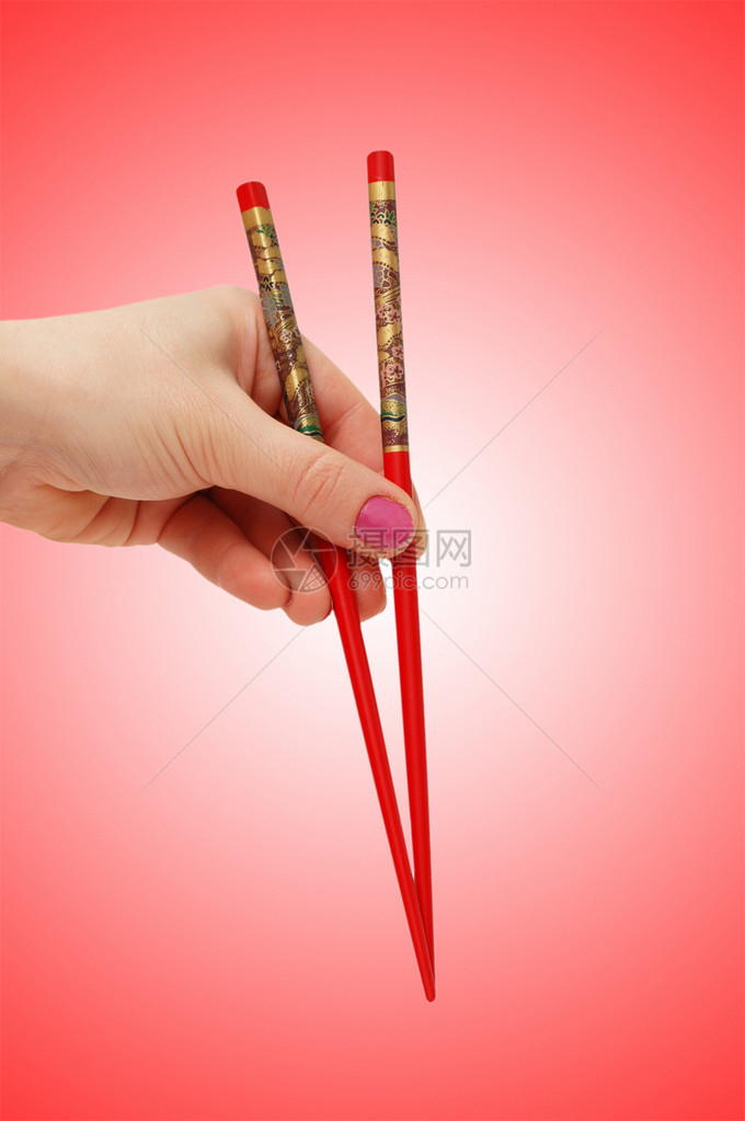 手拿着筷子在渐变上图片