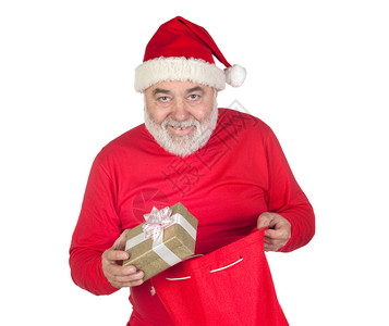 可笑的圣诞老人从他的麻袋里拿礼物孤立图片