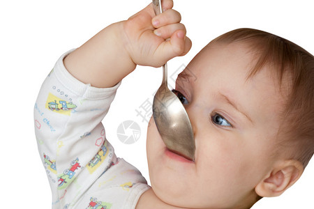 抱着勺子的婴儿女孩在嘴里被图片
